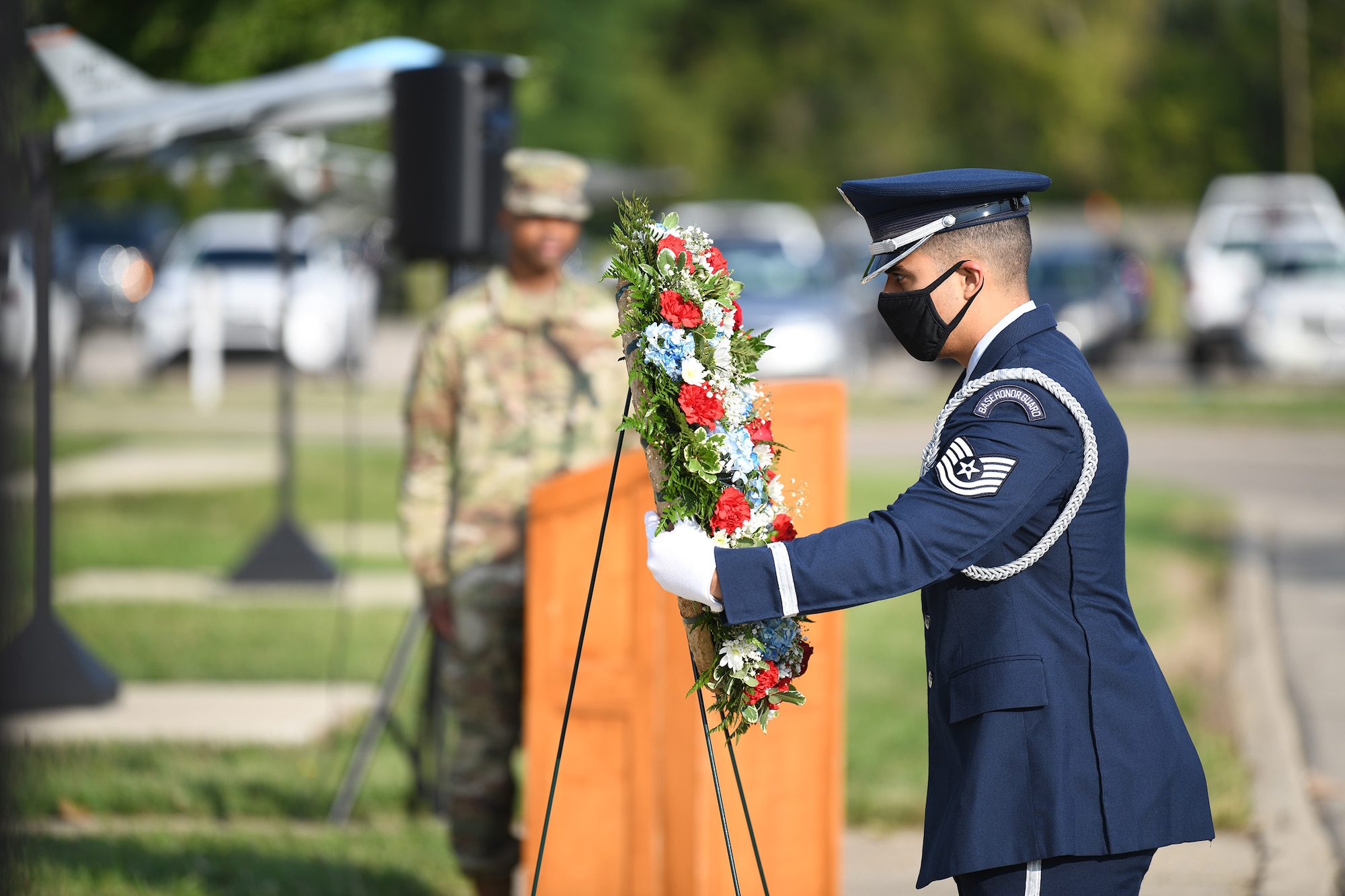 Tech. Sgt. Felipe Henao, 445th Force Support Squadron base honor guard program manager, lays a wreath at the base of a section of the Pentagon that was salvaged from the rubble of the Sept. 11, 2001 terrorist attack, during a 9/11 ceremony here Sept. 11, 2021.