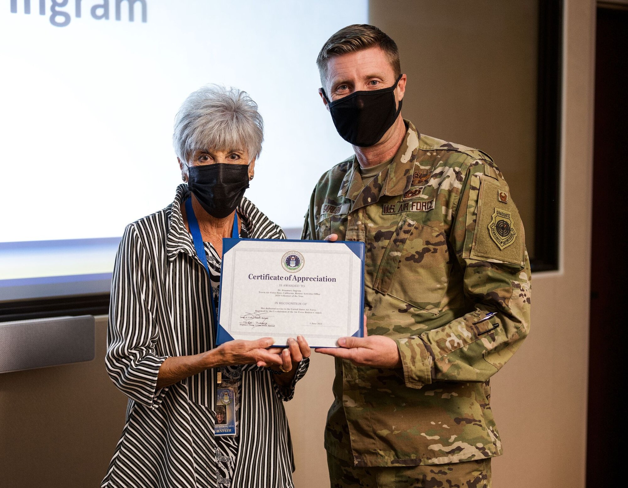 Rosemary Ingram, a volunteer with the Retiree Activities Office at Travis Air Force Base, California, receives the 2020 Air Force Volunteer of the Year Award from U.S. Air Force Col. Ryan Garlow, 60th Air Mobility Wing vice commander, Oct. 6, 2021, inside the Travis AFB headquarters building. Garlow thanked Ingram for her contributions during the ceremony, remarking that her volunteering did much to help the base’s population of retirees. (U.S. Air Force photo by Staff Sgt. Christian Conrad)