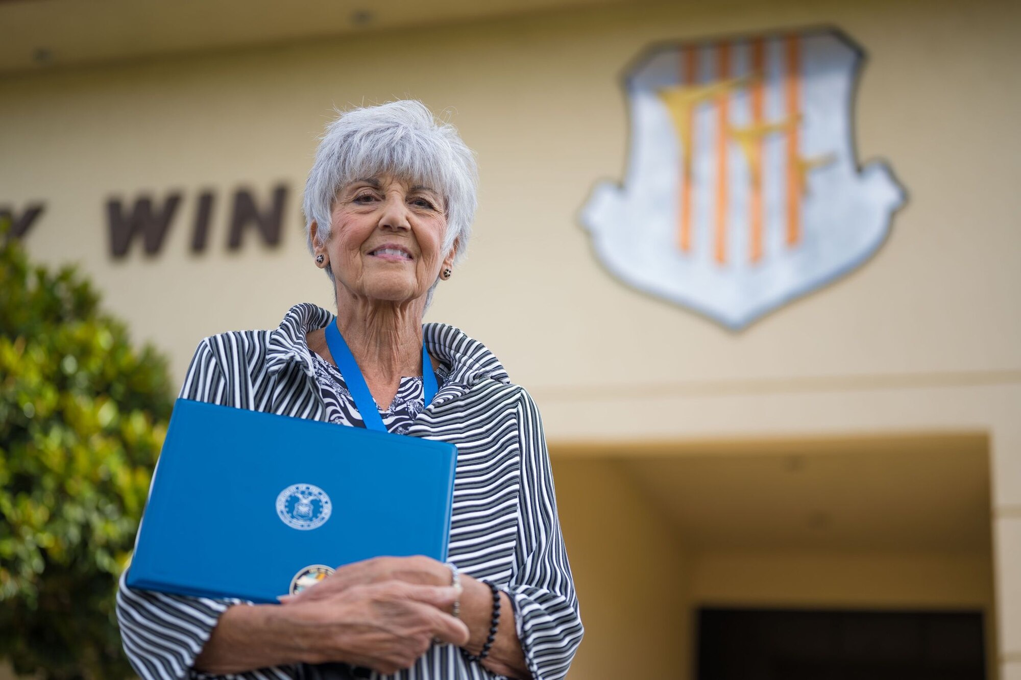 Rosemary Ingram, a volunteer with the Retiree Activities Office at Travis Air Force Base, California, poses for a photo with the 2020 Air Force Volunteer of the Year Award Oct. 6, 2021, at the Travis AFB headquarters building. Throughout the year, Ingram had volunteered on multiple projects both for the Retiree Activities Office and David Grant USAF Medical Center. (U.S. Air Force photo by Staff Sgt. Christian Conrad)