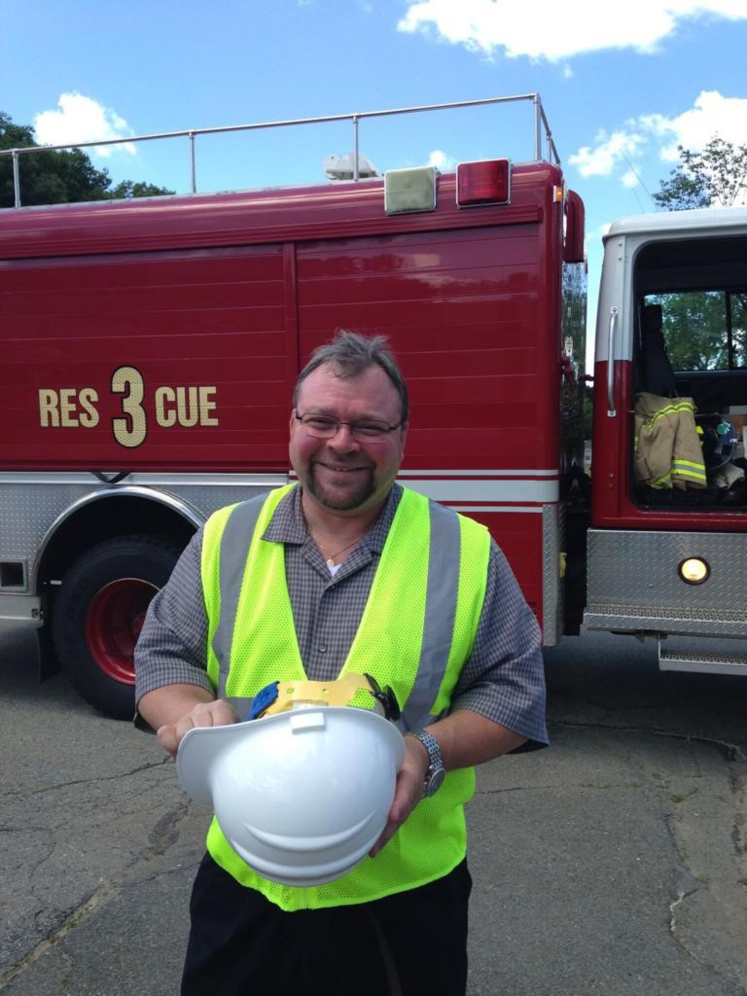 Chris Simpson poses for photo in front of fire truck