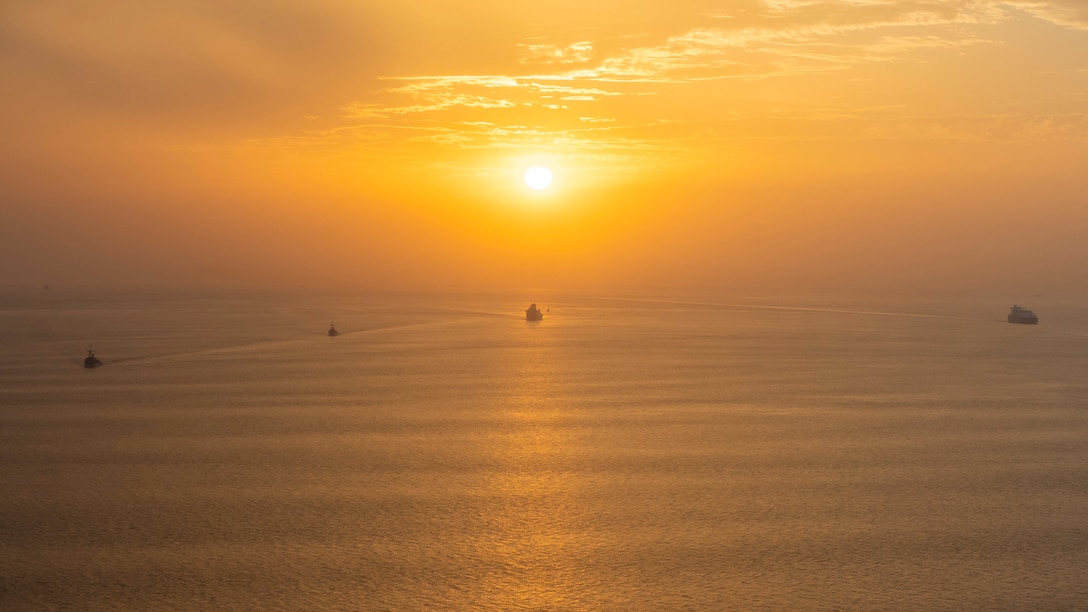 STRAIT OF HORMUZ (Oct. 4, 2021) The amphibious transport dock USS Portland (LPD 27), center, transits the Strait of Hormuz behind the mine countermeasures ships USS Gladiator (MCM 11), far left, and USS Sentry (MCM 3), second from left, Oct. 4. Portland and the 11th Marine Expeditionary Unit are deployed to the U.S. 5th Fleet area of operations in support of naval operations to ensure maritime stability and security in the Central Region, connecting the Mediterranean and Pacific through the Western Indian Ocean and three strategic choke points. (U.S. Marine Corps photo by Lance Cpl. Patrick Katz/Released)