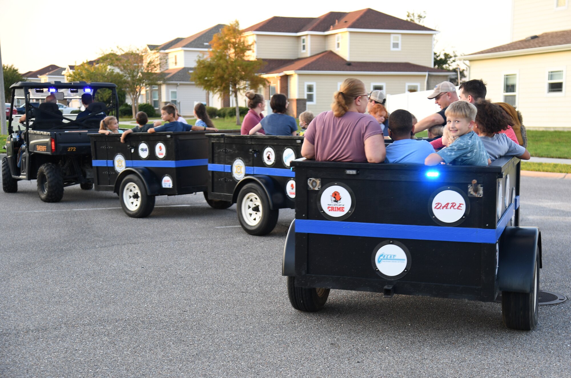 Keesler families ride on the Sheriff Youth Train provided by the Harrison County Sheriff Office during the 81st Security Forces Squadron National Night Out at the Bay Ridge Community Center on Keesler Air Force Base, Mississippi, Oct. 5, 2021. The event, which was held to enhance the relationship between neighbors and law enforcement, included a military working dog demonstration, scavenger hunt and train rides. (U.S. Air Force photo by Kemberly Groue)