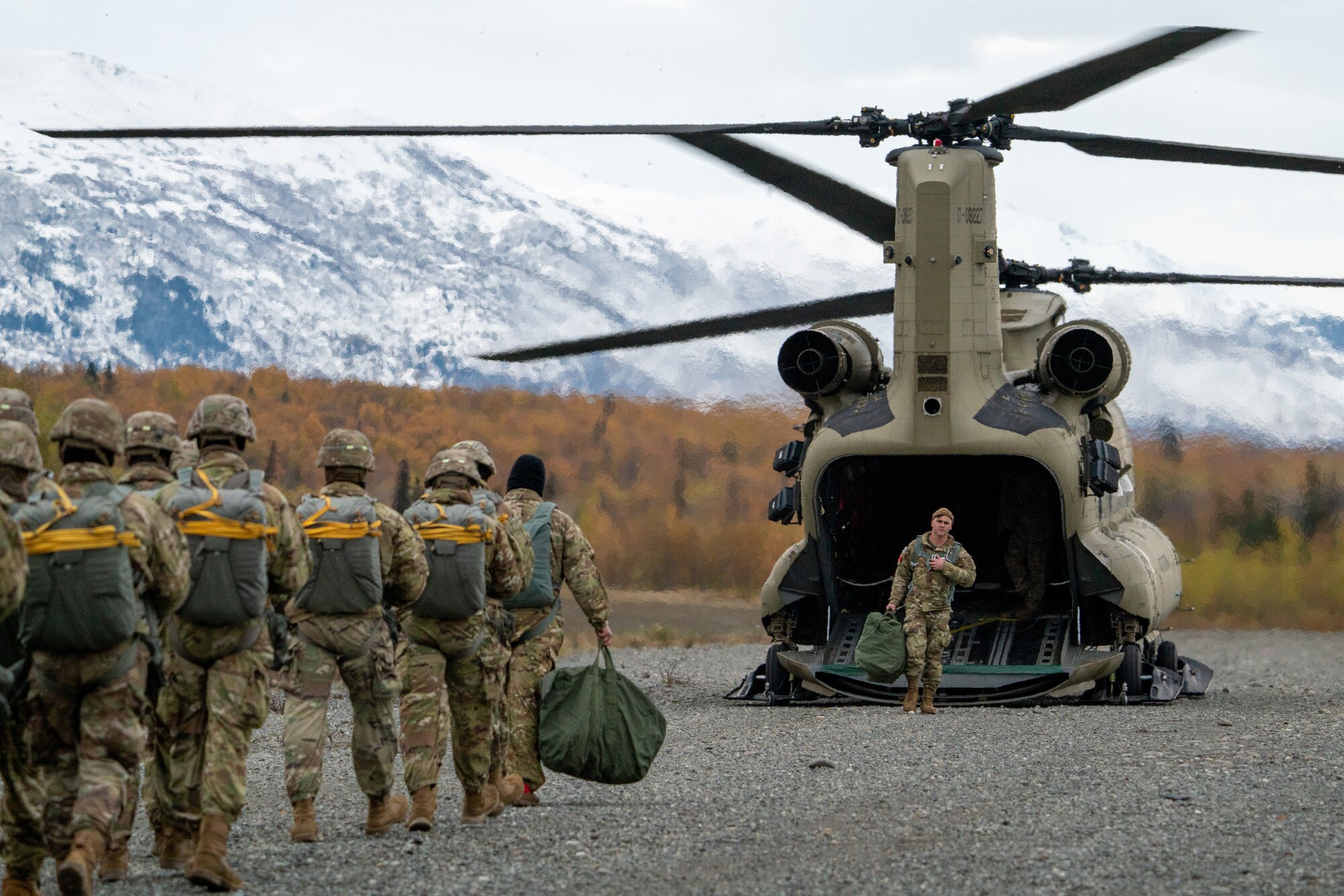 U.S. Army paratroopers assigned to the 4th Infantry Brigade Combat Team (Airborne), 25th Infantry Division, U.S. Army Alaska, prepare to board a CH-47 Chinook.