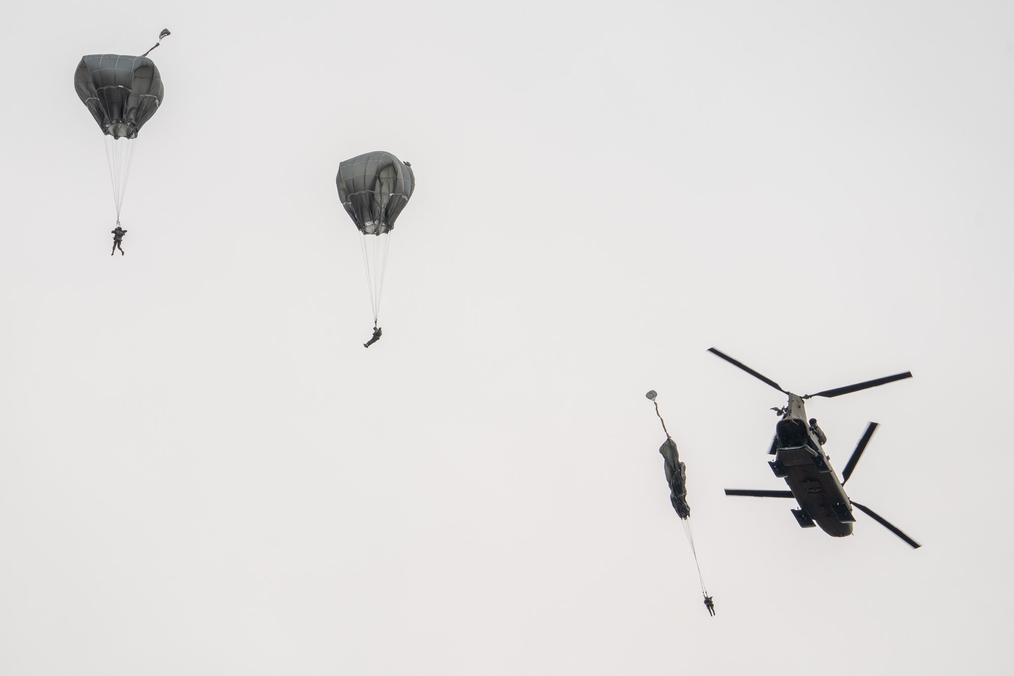 U.S. Army paratroopers assigned to the 4th Infantry Brigade Combat Team (Airborne), 25th Infantry Division, U.S. Army Alaska, jump from a CH-47 Chinook.