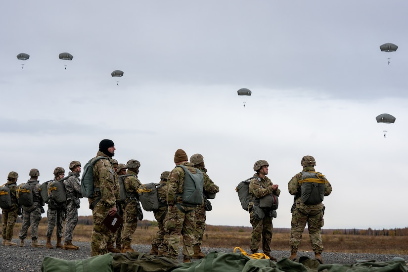 U.S. Army paratroopers assigned to the 4th Infantry Brigade Combat Team (Airborne), 25th Infantry Division, U.S. Army Alaska, observe fellow Soldiers after a jump.