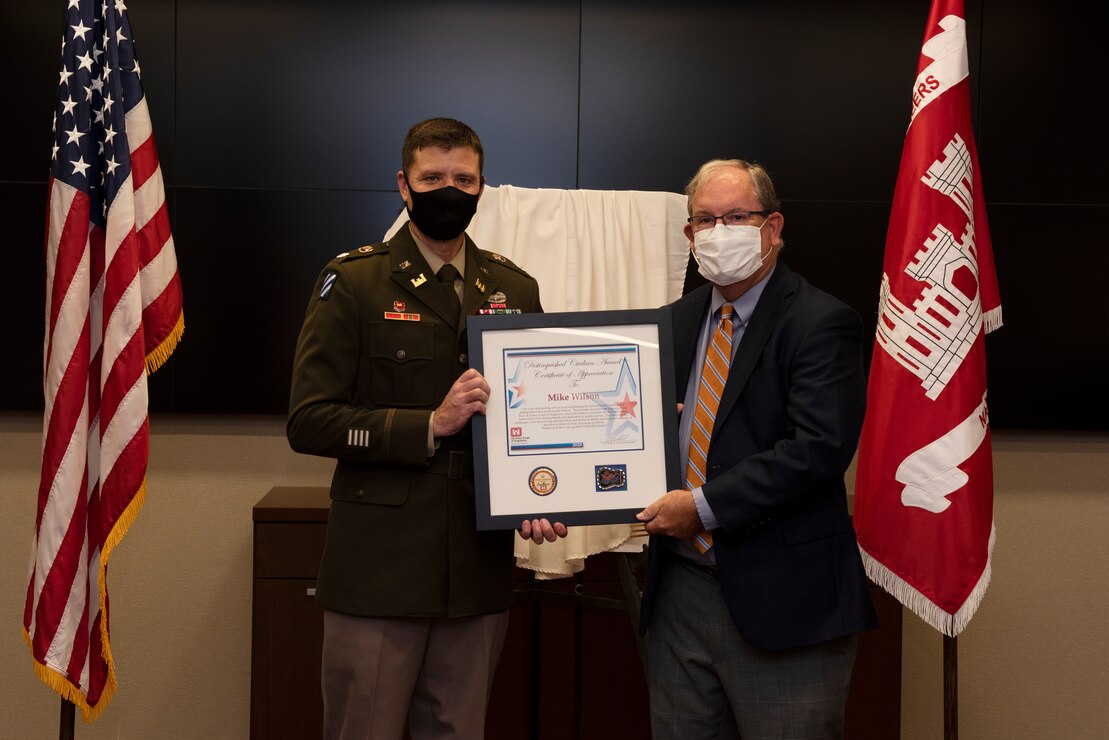 Lt. Col. Joseph Sahl (Left), U.S. Army Corps of Engineers Nashville District commander, presents the 2021 Distinguished Civilian Employee Recognition Award to Retiree Mike Wilson during an award ceremony Oct. 6, 2021 at the Nashville District Headquarters in Nashville, Tennessee. Wilson retired in 2017 following 42 years of federal service, culminating his career as deputy district engineer for Project Management. The position, now referred to as deputy district engineer, is the highest civilian position in the Nashville District. (USACE Photo by Lee Roberts)