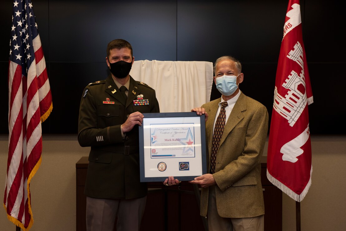 Lt. Col. Joseph Sahl (Left), U.S. Army Corps of Engineers Nashville District commander, presents the 2021 Distinguished Civilian Employee Recognition Award to Retiree Mark Kuhlo during an award ceremony Oct. 6, 2021 at the Nashville District Headquarters in Nashville, Tennessee. Kuhlo retired in 2016 following 35 years of federal service, culminating his career as chief of the Electrical and Mechanical Branch. (USACE Photo by Lee Roberts)