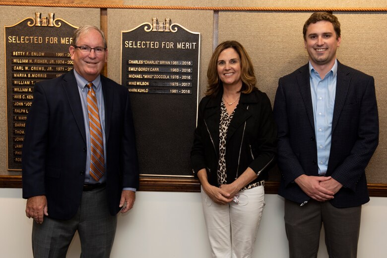 Mike Wilson, 2021 Distinguished Civilian Employee Recognition Award recipient, poses with his wife Cady and son Michael by a nameplate on a bronze plaque highlighting his recognition Oct. 6, 2021 at the Nashville District Headquarters in Nashville, Tennessee. Wilson retired in 2017 following 42 years of federal service, culminating his career as deputy district engineer for Project Management. Kuhlo retired in 2016 following 35 years of federal service, culminating his career as chief of the Electrical and Mechanical Branch. (USACE Photo by Lee Roberts)
