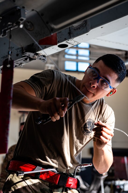 man with tools working on a missile