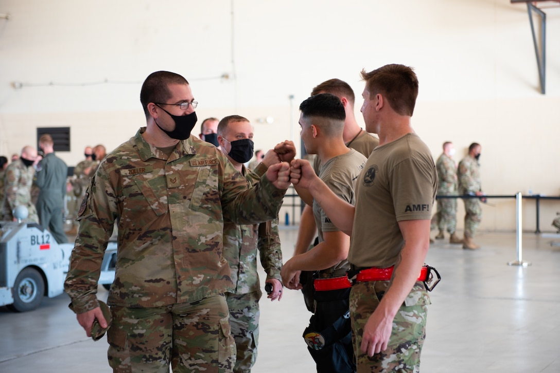 man fist bumping a group of people