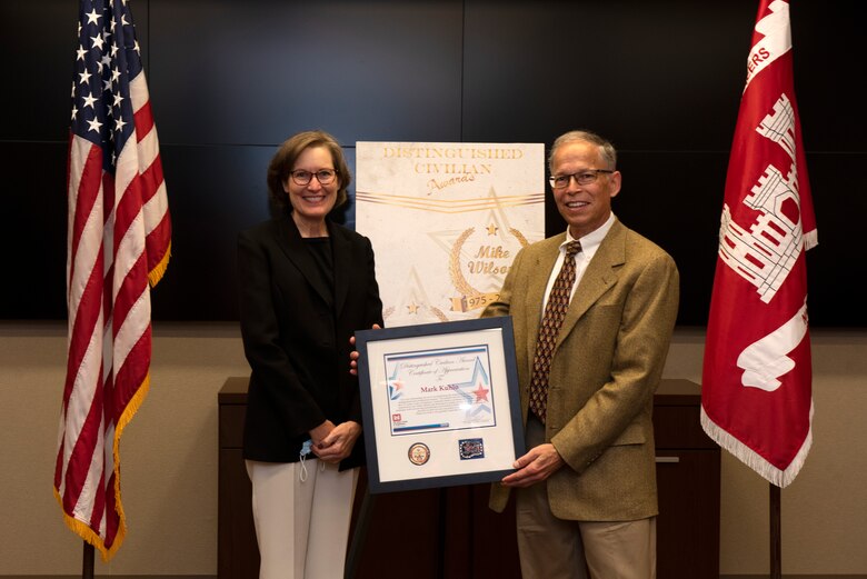 Mark Kuhlo, 2021 Distinguished Civilian Employee Recognition Award recipient, poses with his wife Jeanne while accepting the recognition during an award ceremony Oct. 6, 2021 at the Nashville District Headquarters in Nashville, Tennessee. Kuhlo retired in 2016 following 35 years of federal service, culminating his career as chief of the Electrical and Mechanical Branch. (USACE Photo by Lee Roberts)