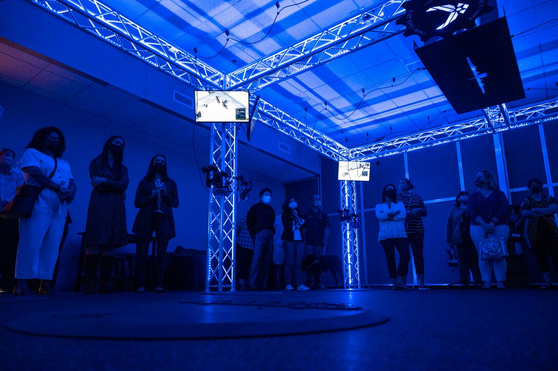 Military spouses stand in the virtual reality training room.
