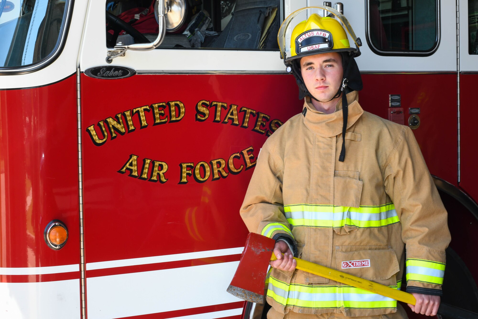U.S. Air Force Airman 1st Class Joseph Coveney, 97th Civil Engineer Squadron (CES) fire prevention specialist, poses next to Engine 11 at the fire department on Altus Air Force Base, Oklahoma, Oct. 4, 2021. The 97th CES Fire and Emergency Services Flight hosted Fire Prevention Week from October 4-9, where they hosted multiple educational activities throughout the week. (U.S. Air Force photo by Airman 1st Class Trenton Jancze)