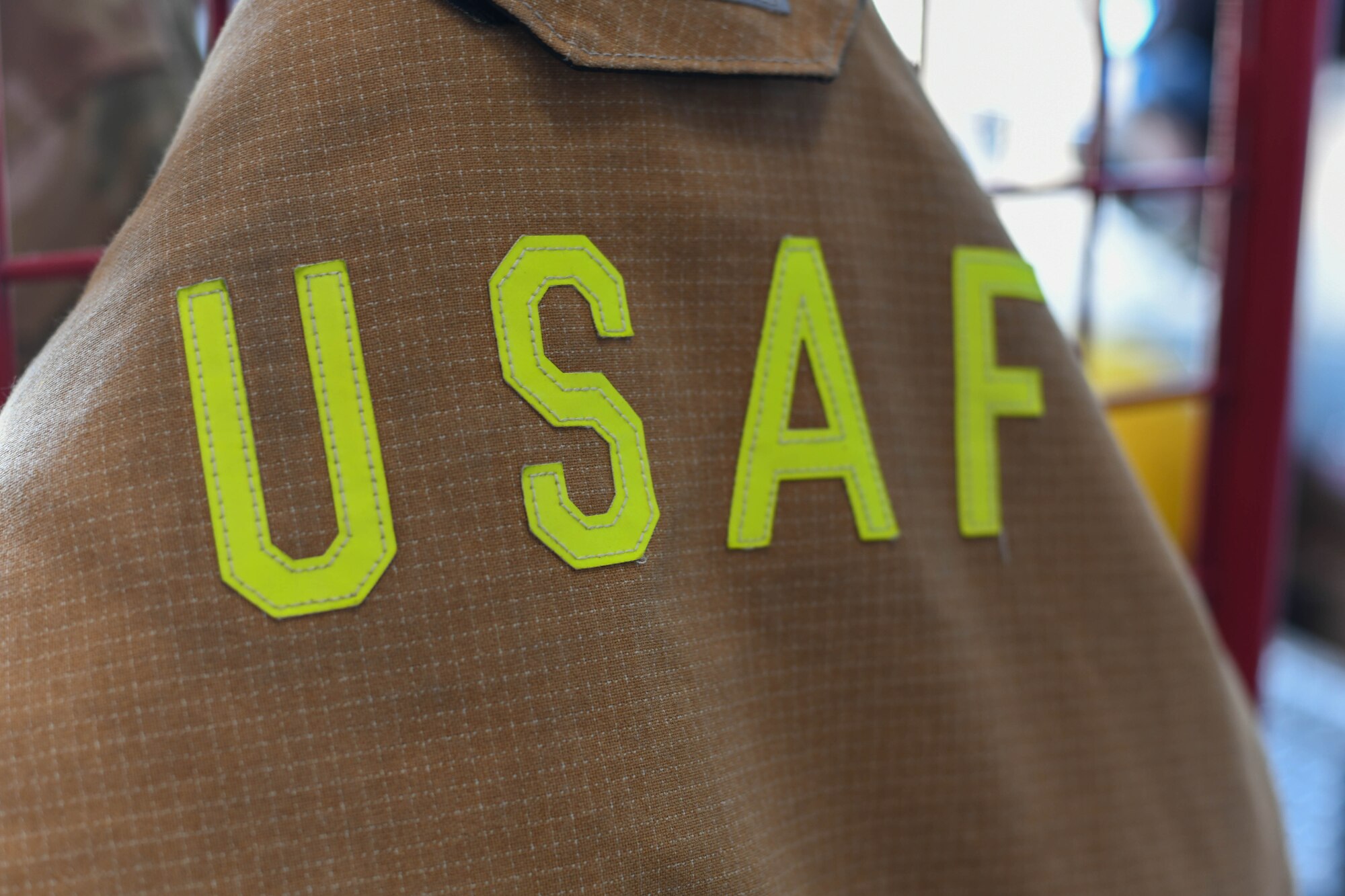 A turnout coat belonging to U.S. Air Force Airman 1st Class Joseph Coveney, 97th Civil Engineer Squadron (CES) fire prevention specialist, hangs at the fire department on Altus Air Force Base, Oklahoma, Oct. 4, 2021. The 97th CES promoted this year’s Fire Prevention Week campaign of “learn the sounds of fire safety” by educating families about the different sounds smoke and carbon monoxide alarms make. (U.S. Air Force photo by Airman 1st Class Trenton Jancze)