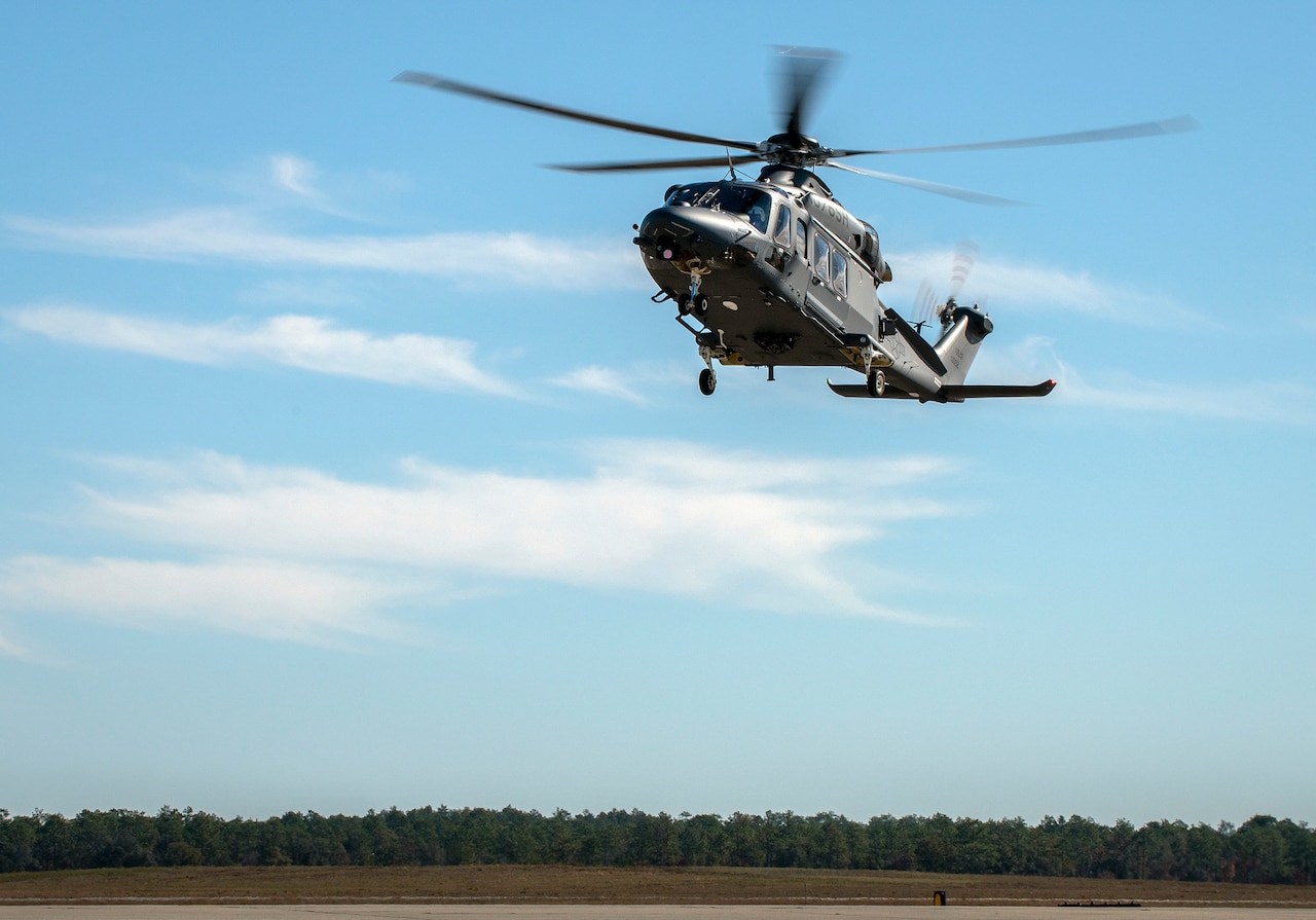 A helicopter hovers above an airfield.