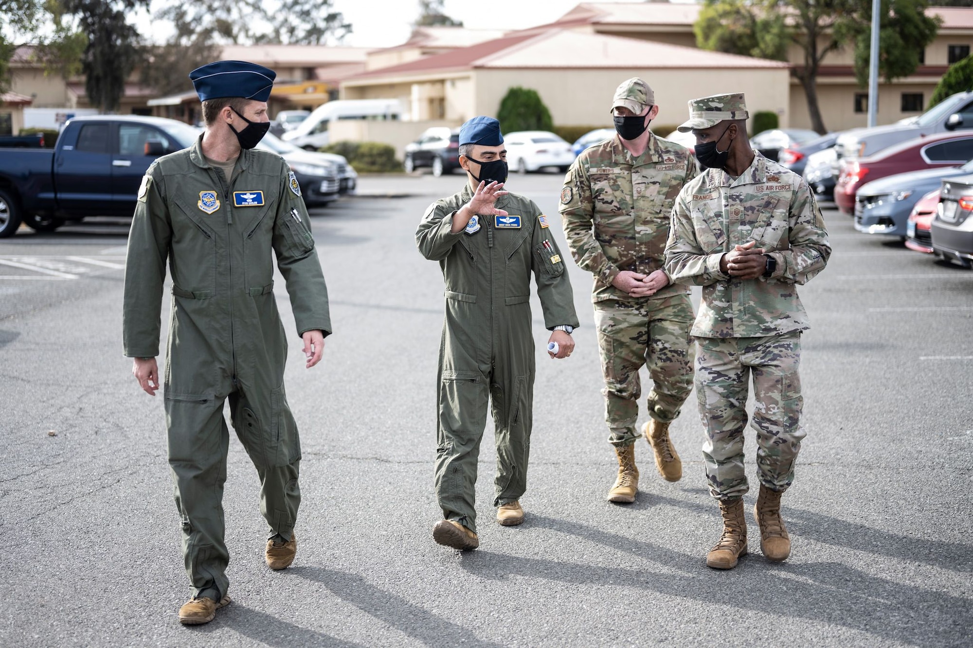 U.S. Air Force Col. Ryan Garlow, left, 60th Air Mobility Wing vice commander, and Chief Master Sgt. Erick Fierro, center left, 60th AMW interim command chief, speak with Master Sgt. Michael Powers, center right, and Master Sgt. Mario Francis, both 60th AMW Honor Guard superintendents, during Leadership Rounds Oct. 7, 2021, at Travis Air Force Base, California. Garlow and Fierro toured the base’s Honor Guard building, Child Development Center and dining facility to see a sample of the 60th Force Support Squadron mission. The Leadership Rounds program is designed to provide 60th AMW leadership an opportunity to interact with Airmen and receive a detailed view of each mission performed at Travis AFB. (U.S. Air Force photo by Staff Sgt. Christian Conrad)