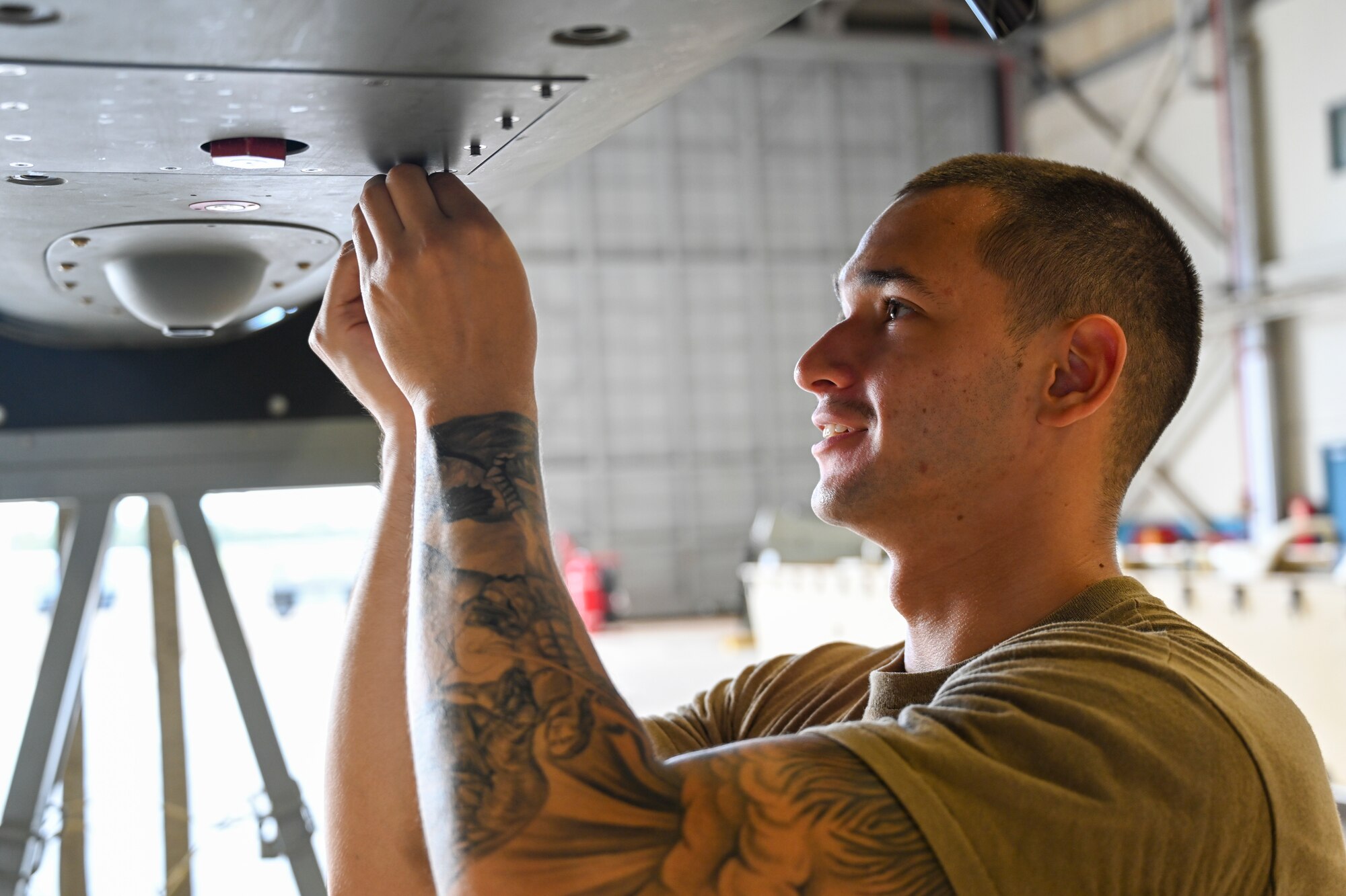 Senior Airman Paulo Diaz, 49th Aircraft Maintenance Squadron dedicated crew chief, re-installs a panel on a MQ-9 Reaper, Oct. 10, 2021, on Marine Corps Base Hawaii. Diaz is a participant in Exercise Agile Combat Employment Reaper and his role is to maintain, recover and ensure multiple MQ-9 aircraft, temporarily stationed at Hawaii, are mission ready. Exercise ACE Reaper demonstrates the ability to rapidly mobilize MQ-9 assets and personnel, and integrate platforms across multiple domains anywhere in the world. (U.S. Air Force photo by Airman 1st Class Adrian Salazar)