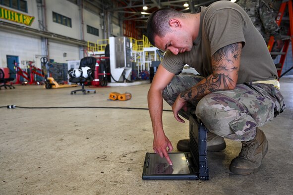 Senior Airman Paulo Diaz, 49th Aircraft Maintenance Squadron dedicated crew chief, reads the technical order for a MQ-9 Reaper, Oct. 10, 2021, on Marine Corps Base Hawaii. A technical order is an official medium for disseminating technical information, instructions and safety precautions pertaining to equipment and systems. Exercise Agile Employment Reaper provided training for multi-capable Airmen, who are able to move quickly, complete a mission, and return to home station faster than a large team and without as much airlifted equipment. (U.S. Air Force photo by Airman 1st Class Adrian Salazar)