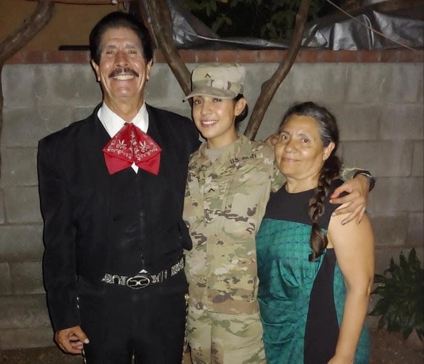 Army Reserve Spc. Luz Hernandez, who is currently deployed to Camp Buehring, Kuwait, with the South El Monte, California, based 155th Combat Sustainment Support Battalion, shares a moment with her parents, Angel Hernandez Mendoza and Maria Guadalupe Lopez- Hernandez. Hernandez said she draws strength from her parents’ legacy. “I am sure there are Mexican heroes, but for me, it was just hearing my dad's and my mom's stories—how they came from nothing in Mexico.” (Photo courtesy of Spc. Luz Hernandez)