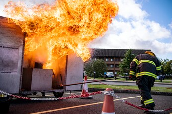 Dave Herman, 423rd Civil Engineer Squadron assistant chief of fire prevention, demonstrates a grease fire during a safety briefing at RAF Alconbury, England, Oct. 4, 2021.The demonstration was a part of Fire Prevention Week which allowed firefighters from the 423rd CES to educate Airmen and family members from the 501st Combat Support Wing on proper fire safety habits. (U.S. Air Force photo by Senior Airman Eugene Oliver)