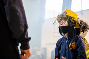 A student from Alconbury Elementary school participates in a fire station open house at RAF Alconbury, England, Oct. 7, 2021. The open house was a part of Fire Prevention Week which allowed firefighters from the 423rd CES to educate Airmen and family members from the 501st Combat Support Wing on proper fire safety habits. (U.S. Air Force photo by Senior Airman Eugene Oliver)