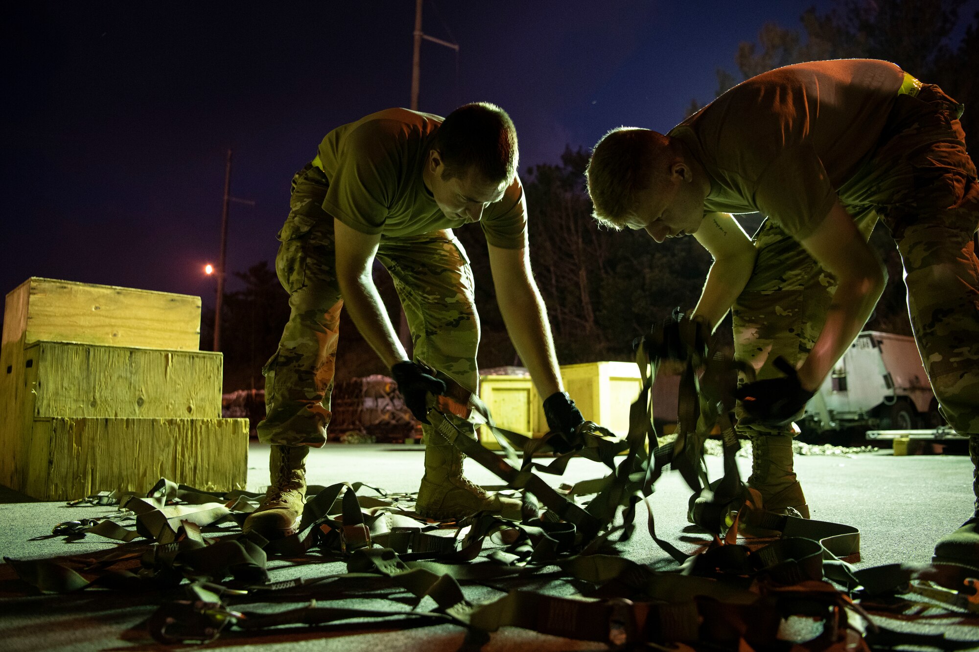 Two 18th MUNS Airmen build pallets