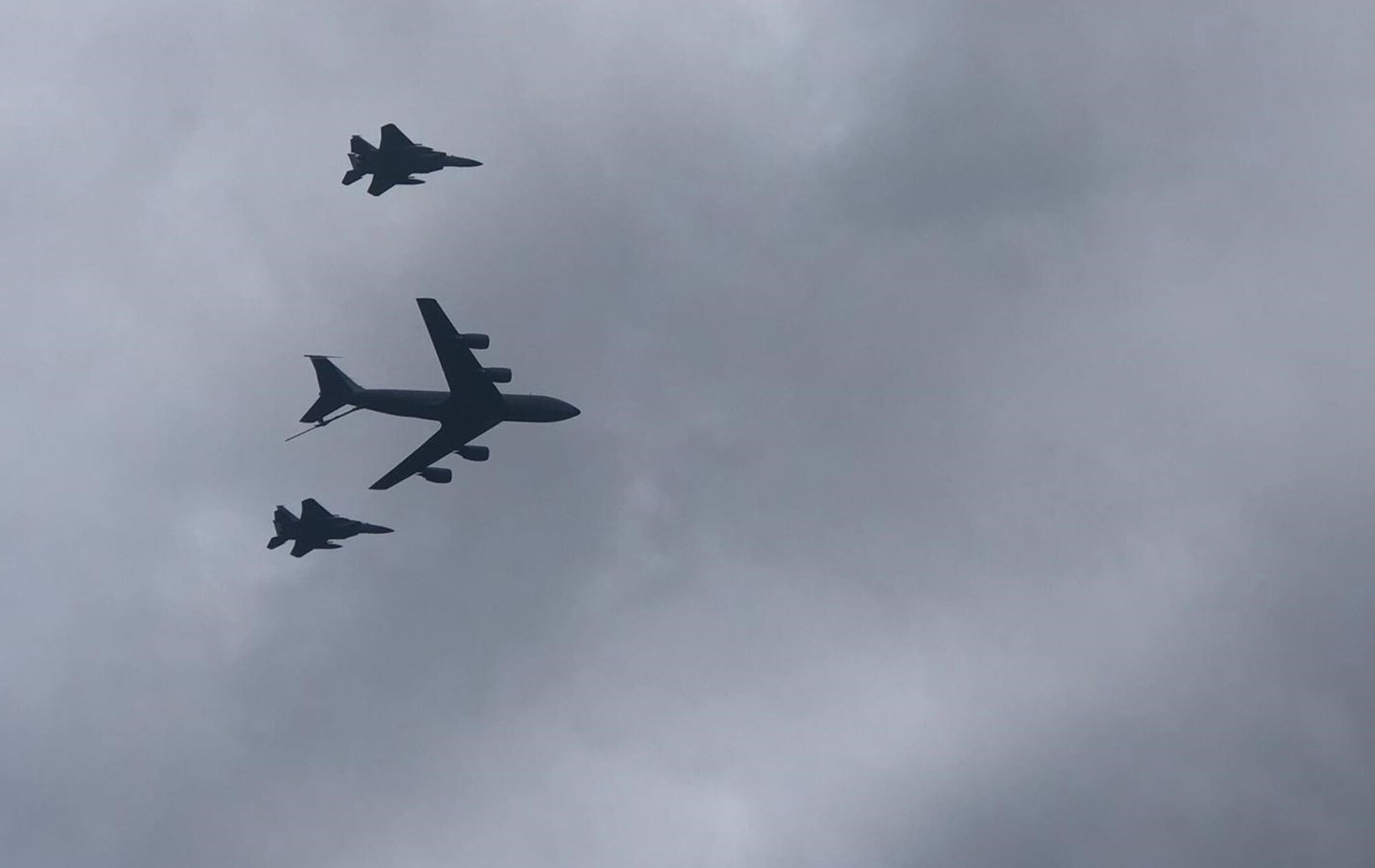 Two U.S. Air Force F-15 Eagle aircraft from Royal Air Force Lakenheath and a U.S. Air Force KC-135 Stratotanker aircraft from Royal Air Force Mildenhall fly over Lielvarde Air Base, Latvia during an instrument flight rules certification ceremony, September 2021.