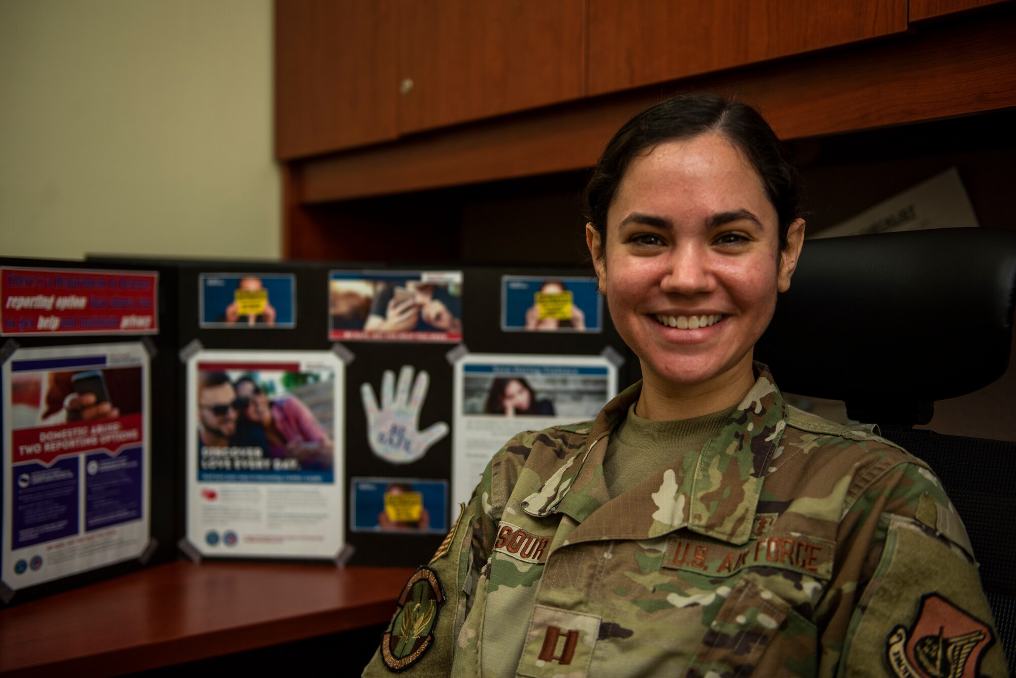 Capt. Amanda Mansour, 51st Operational Medical Readiness Squadron family advocacy officer, displays educational material for Domestic Violence Prevention Awareness Month