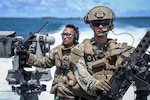 Electronics Technician 3rd Class Paul Shaffer of the Navy's Maritime Expeditionary Security Squadron 4 trains with Sgt. Keoni Wong, flight medic with the Guam Army National Guard, aboard a Mark VI Patrol Boat during a joint exercise in Guam, Sept. 28, 2021.