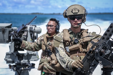 Electronics Technician 3rd Class Paul Shaffer of the Navy's Maritime Expeditionary Security Squadron 4 trains with Sgt. Keoni Wong, flight medic with the Guam Army National Guard, aboard a Mark VI Patrol Boat during a joint exercise in Guam, Sept. 28, 2021.