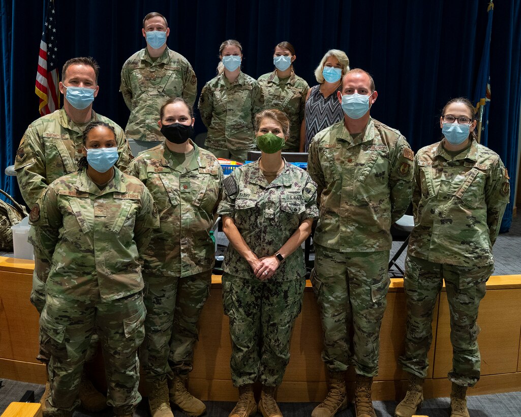 Rear Adm. Kristen Fabry (center), Defense Logistics Agency Land and Maritime commander, poses Oct. 1, 2021, with a group of 88th Medical Group Airmen during a visit to the Medical Center at Wright-Patterson Air Force Base, Ohio. The Airmen were part of a team that traveled to Columbus earlier this year to administer COVID-19 vaccines to DLA members in Fabry’s command, and she wanted to personally thank them. (U.S. Air Force photo by R.J. Oriez)
