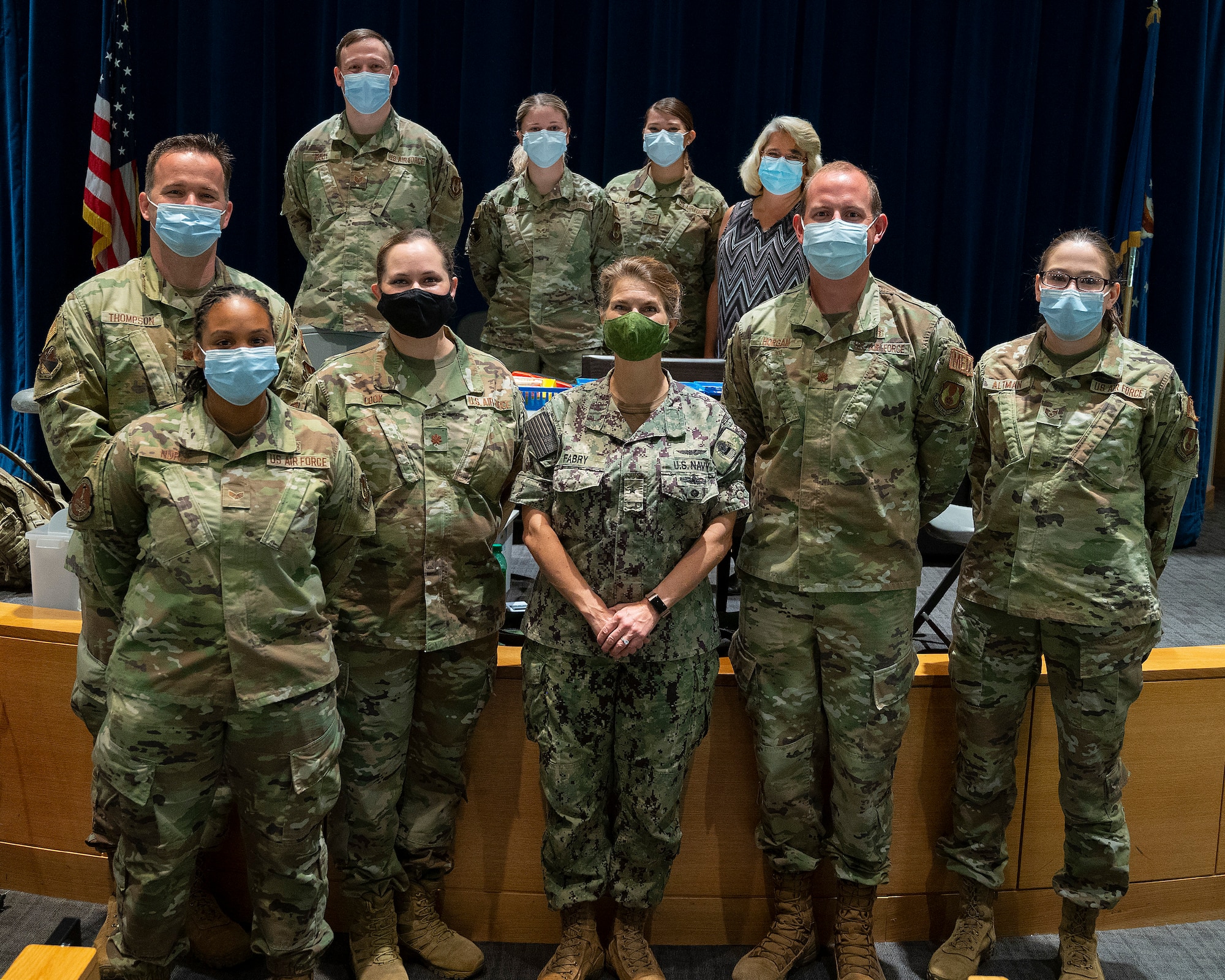 Rear Adm. Kristen Fabry (center), Defense Logistics Agency Land and Maritime commander, poses Oct. 1, 2021, with a group of 88th Medical Group Airmen during a visit to the Medical Center at Wright-Patterson Air Force Base, Ohio. The Airmen were part of a team that traveled to Columbus earlier this year to administer COVID-19 vaccines to DLA members in Fabry’s command, and she wanted to personally thank them. (U.S. Air Force photo by R.J. Oriez)