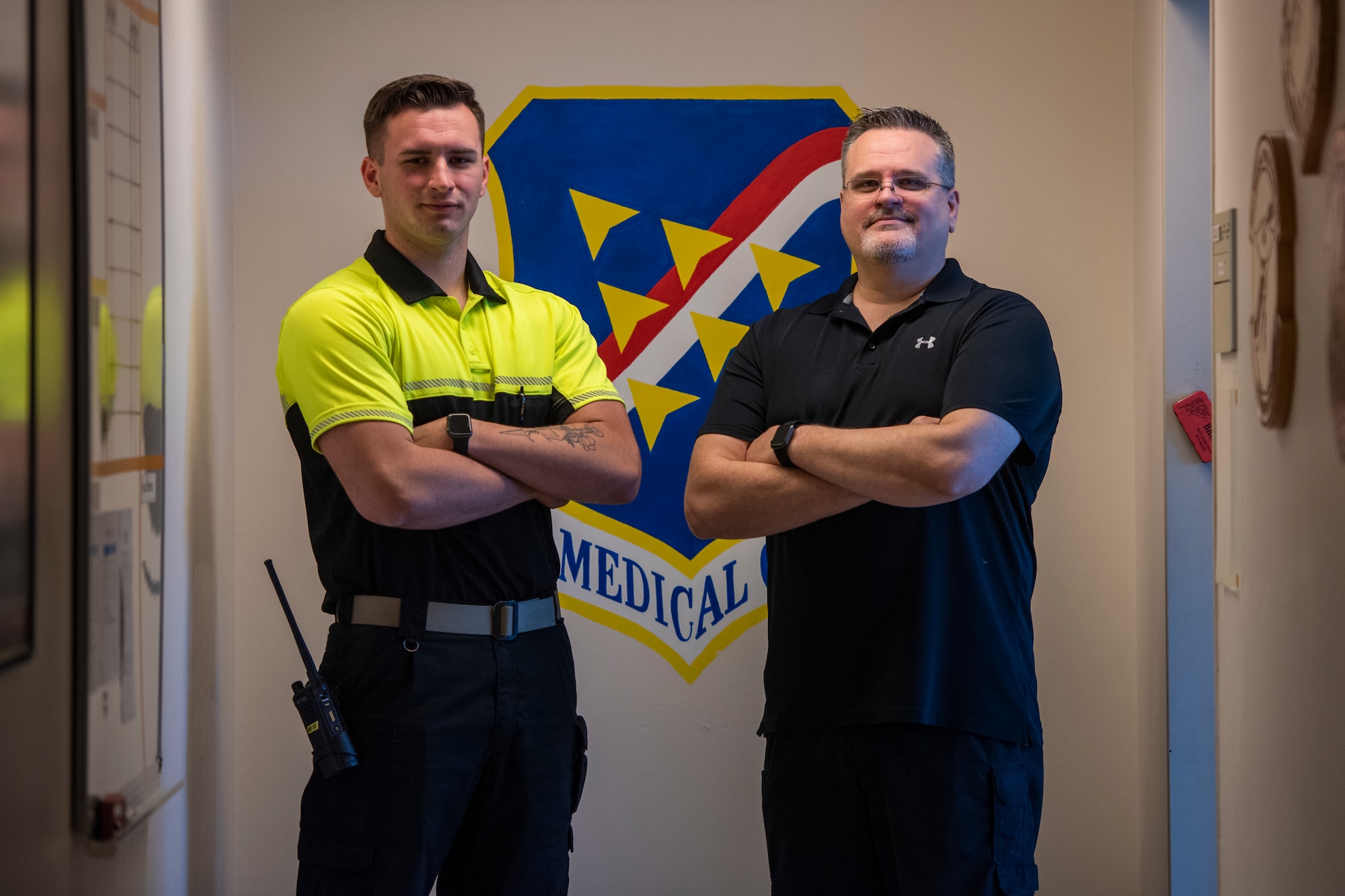 Two men stand and pose for photo.