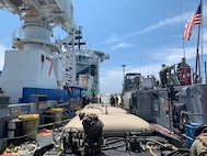 Marines from 8th Engineer Support Battalion, Bulk Fuel Company 1st Platoon transfer fuel from an off-shore vessel into collapsible fabric tanks aboard Assault Craft Unit Two landing craft utility 1662 as part of Large-Scale Exercise (LSE 2021), Aug. 8, 2021.