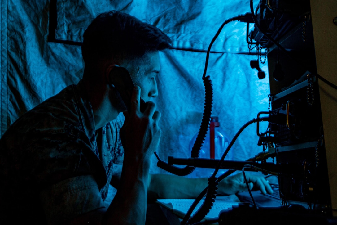 A Marine operates communications gear.