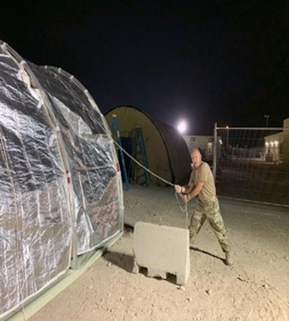 Man putting up a tent.
