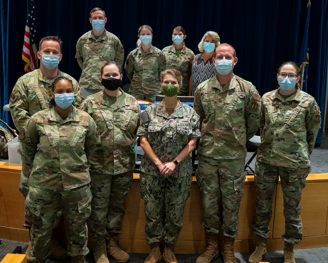 Rear Adm. Kristen Fabry (center), Defense Logistics Agency Land and Maritime commander, poses Oct. 1, 2021, with a group of 88th Medical Group Airmen during a visit to the Medical Center at Wright-Patterson Air Force Base, Ohio. The Airmen were part of a team that traveled to Columbus earlier this year to administer COVID-19 vaccines to DLA members in Fabry’s command, and she wanted to personally thank them. (U.S. Air Force photo by R.J. Oriez)