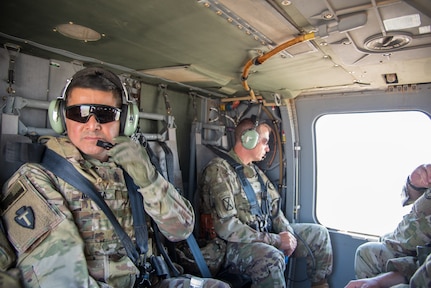 Command Sgt. Maj. Javier Acosta and Brig. Gen. Charles Hausman on helicopter flight while deployed to Iraq in 2019.