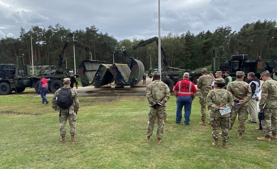 Team members from Army Prepositioned Stock-2 worksite Zutendaal, Army Field Support Battalion Benelux, 405th Army Field Support Brigade, check the operational functionality of an Improved Ribbon Bridge at Army Prepositioned Stock-2 worksite Zutendaal in Belgium.