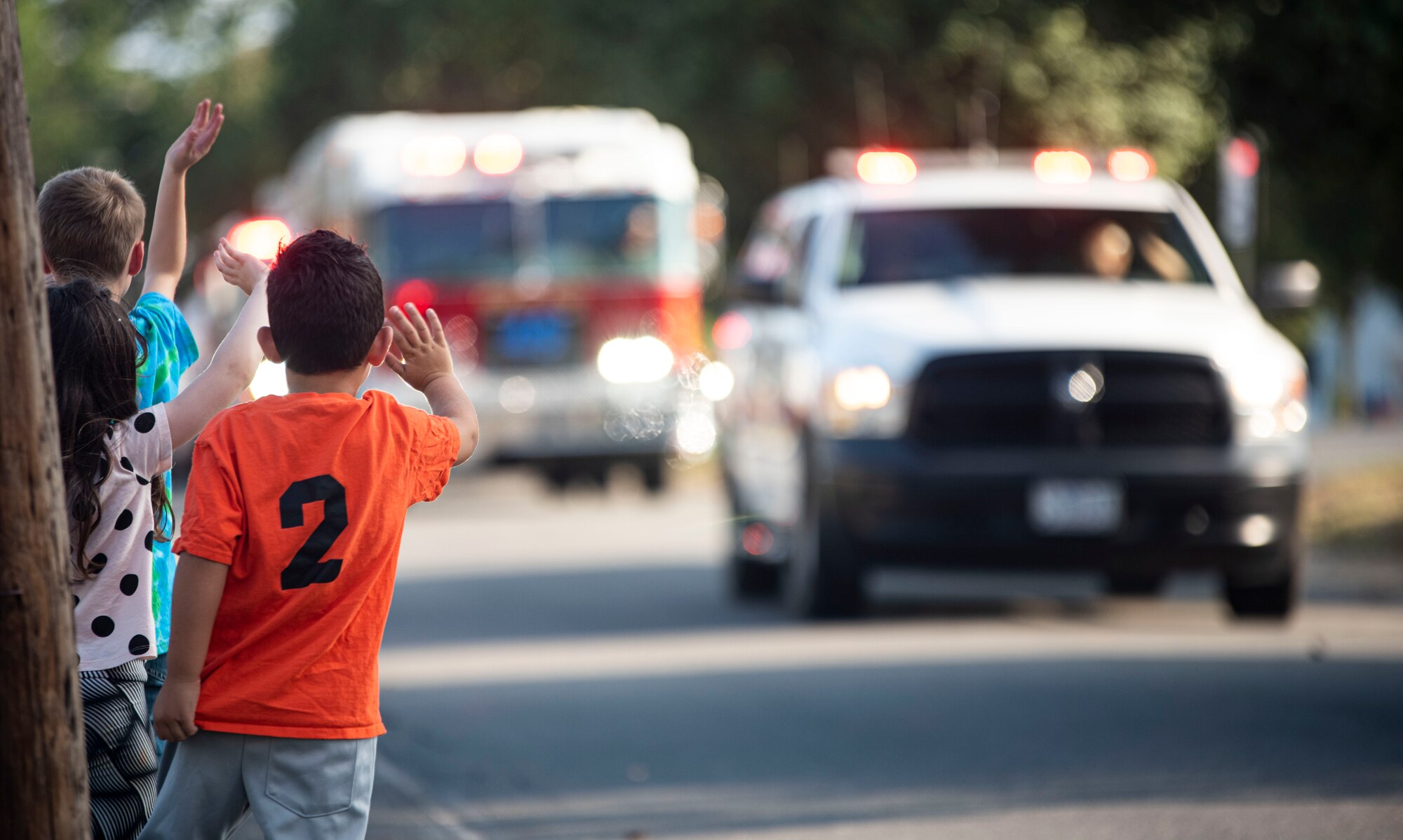 Children wave at Firemen with the 87th Civil Engineering Squadron during the Fire Prevention Week Parade, Oct. 6, 2021, at Joint Base MDL, N.J. Fire Prevention Week is observed each year during the week of October 9th in commemoration of the Great Chicago Fire, which began on October 8, 1871. (U.S. Air Force Photo by Airman 1st Class Matt Porter)