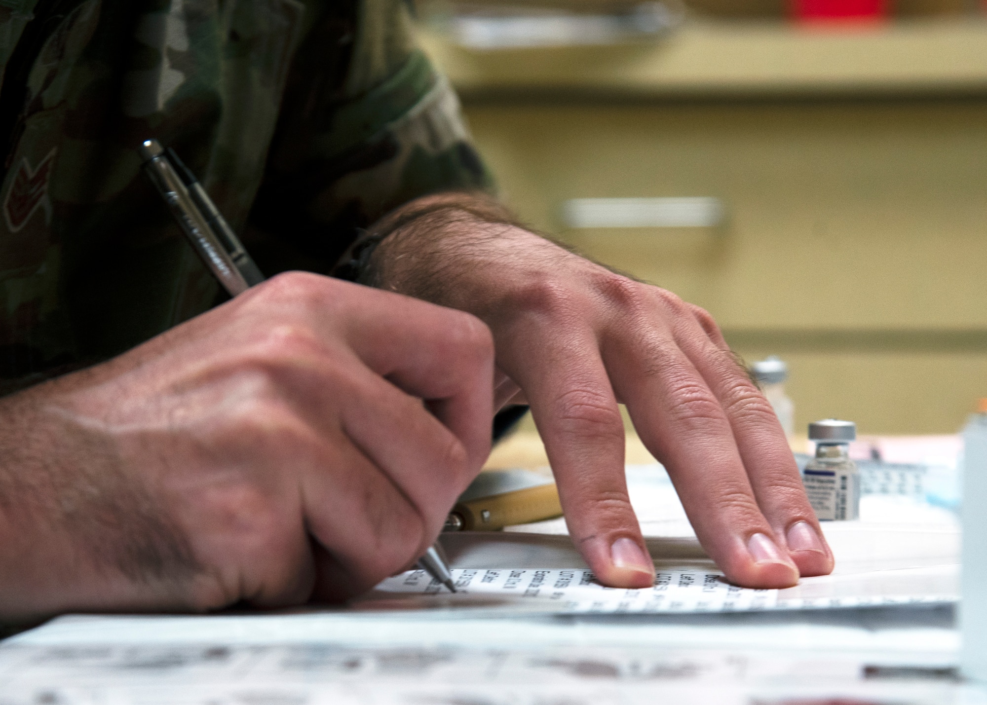 Staff Sgt. James Stephens from the 6th Medical Support Squadron annotates dates on labels while preparing COVID-19 vaccines for distribution at MacDill Air Force Base, Florida, Sept. 30, 2021.