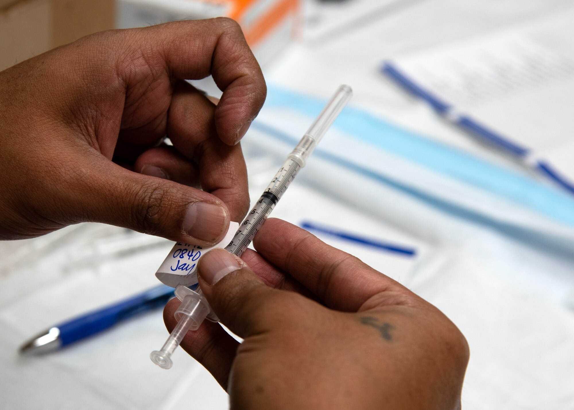 Jay Naigan, a contractor from the 6th Medical Support Squadron, prepares a COVID-19 vaccine for distribution at MacDill Air Force Base, Florida, Sept. 30, 2021.
