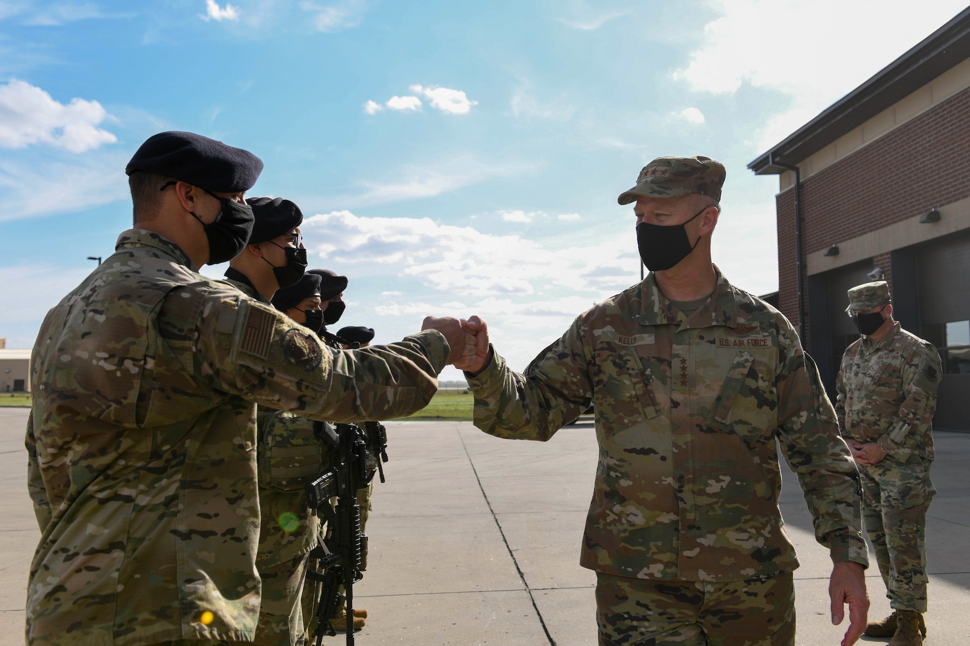 U.S. Air Force Gen. Mark Kelly, commander of Air Combat Command, fist bumps Airmen from the 319th Security Forces Squadron during a visit to Grand Forks Air Force Base, N.D., Oct. 7, 2021. Kelly took the opportunity to express his gratitude and acknowledge the Airmen’s hard work and dedication to protecting people and assets on a daily basis. (U.S. Air Force photo by Airman 1st Class Ashley Richards)