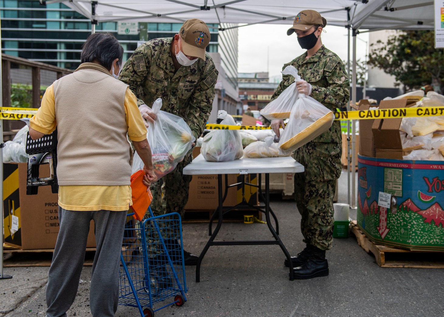 Sailors dispense food during a San Francisco Fleet Week 2021 community service project at SF-Marin Food Bank.