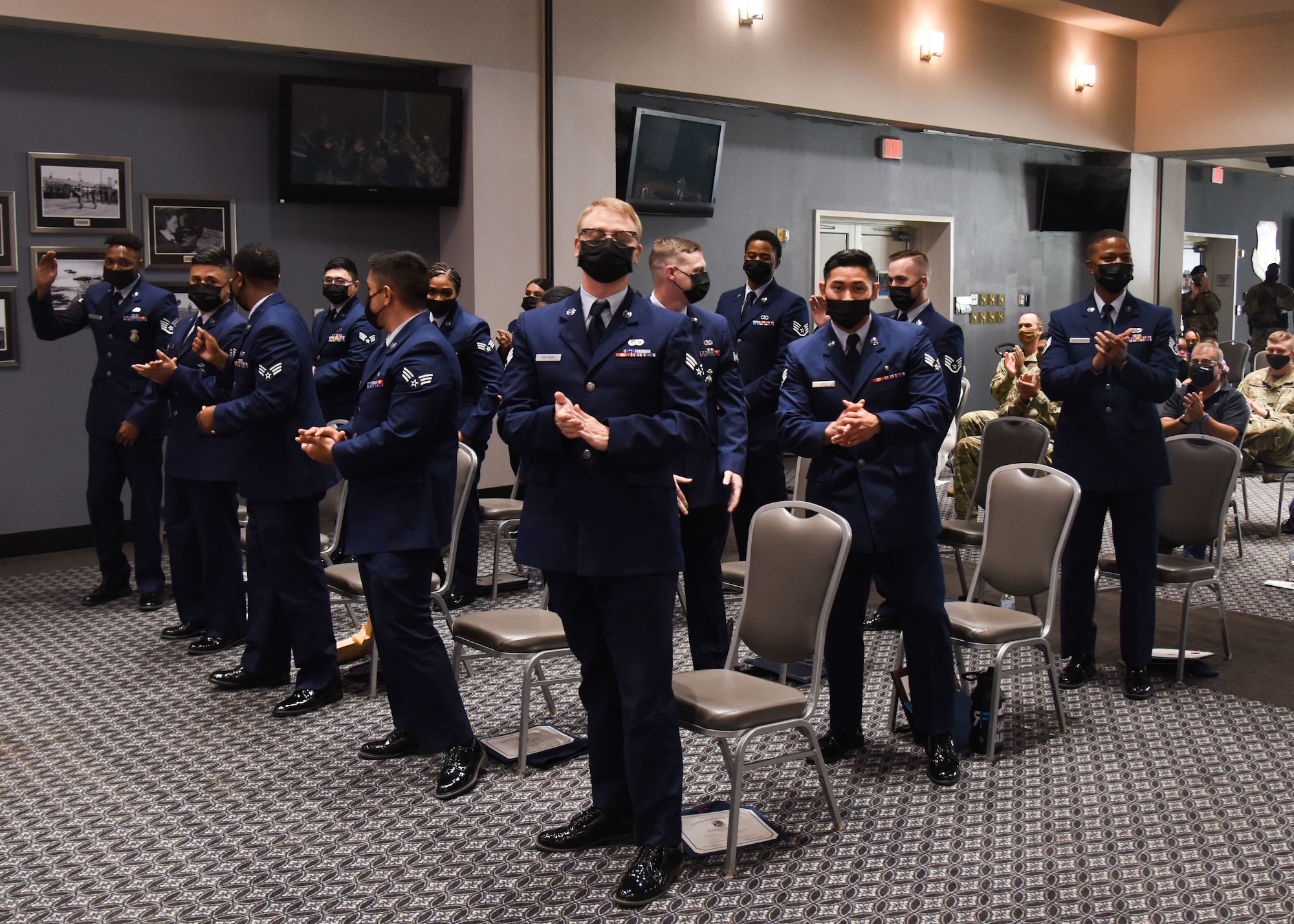 Graduates of Airman Leadership School Class 21-G stand as they are recognized during the the ALS graduation ceremony on Goodfellow Air Force Base, Texas, Oct. 8, 2021. Class 21-D graduated 15 Airmen into front-line supervisors. (U.S. Air Force photo by Staff Sgt. Tyrell Hall)