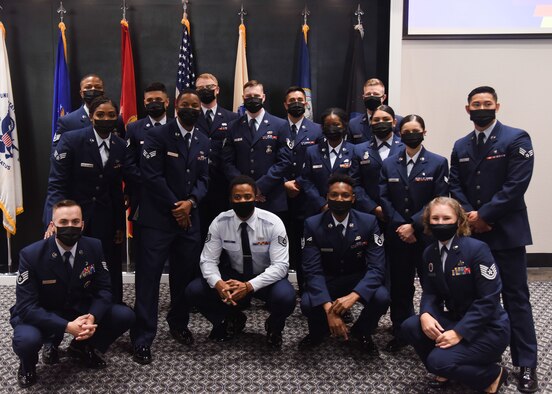Graduates of Airman Leadership School Class 21-G pose for a group picture during the ALS graduation ceremony on Goodfellow Air Force Base, Texas, Oct. 8, 2021. ALS focuses on developing leadership abilities, the profession of arms and building effective communication. (U.S. Air Force photo by Staff Sgt. Tyrell Hall)
