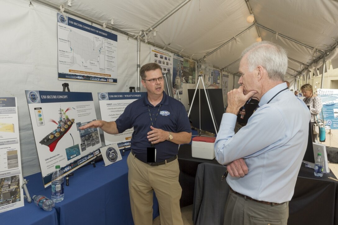 A Navy cyber engineer gives a cyber security briefing.