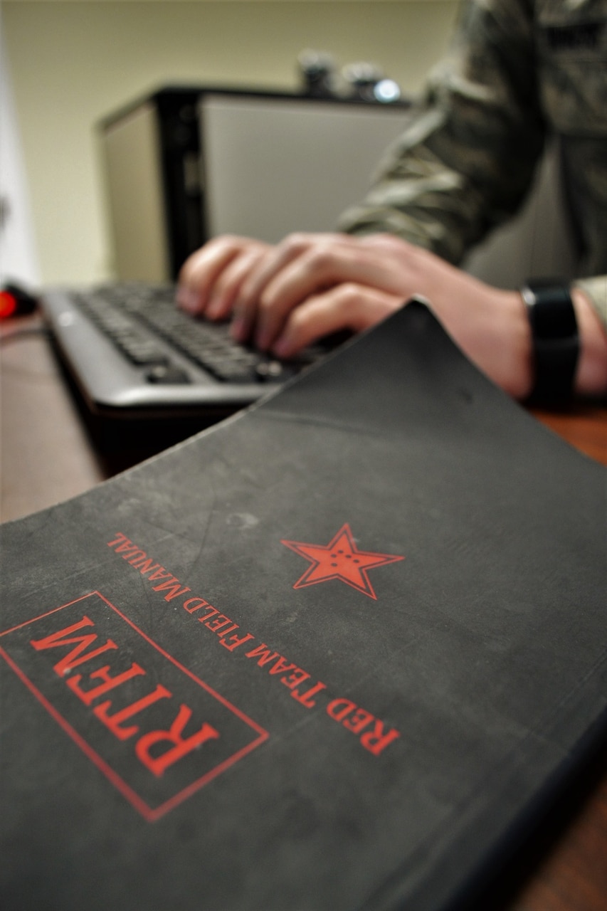 A service member works on a cyber-attack simulation.