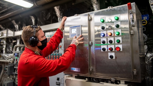 Engineman 1st Class Scott Kruse, from Murrieta, Calif., uses a fuel conditioning control panel aboard the Independence-variant littoral combat ship USS Charleston (LCS 18), during routine operations.