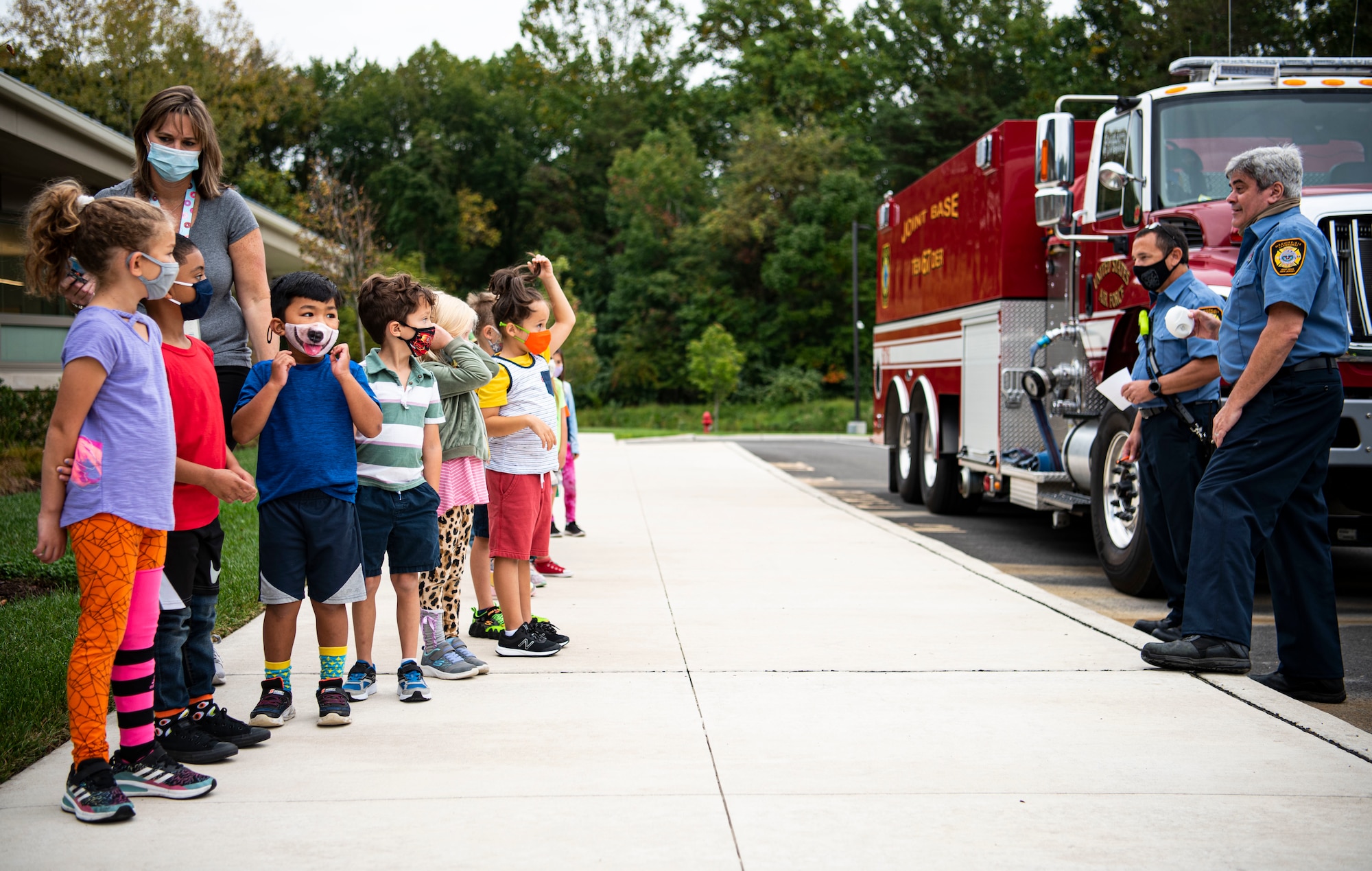 Firemen with the 87th Civil Engineering Squadron instruct school children in fire prevention, Oct. 6, 2021, at Joint Base MDL, N.J. Fire Prevention Week is observed each year during the week of October 9th in commemoration of the Great Chicago Fire, which began on October 8, 1871. (U.S. Air Force Photo by Airman 1st Class Matt Porter)